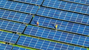 Aerial view showcasing a vast array of solar panels installed on a sunny landscape, highlighting renewable energy use.